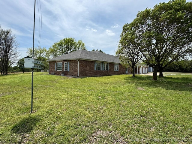 402325 W 2100th Rd, Bartlesville, OK 74006 - view of home's exterior featuring brick siding, a yard, and a garage