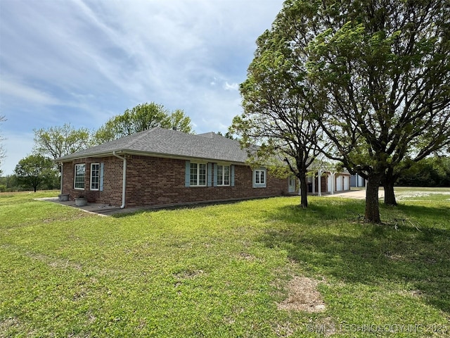 402325 W 2100th Rd, Bartlesville, OK 74006 - view of property exterior with brick siding, a lawn, and driveway