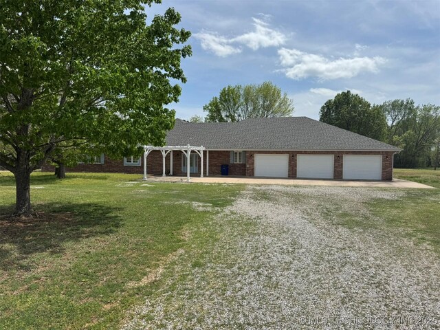402325 W 2100th Rd, Bartlesville, OK 74006 - ranch-style house with a pergola, gravel driveway, an attached garage, a front lawn, and brick siding