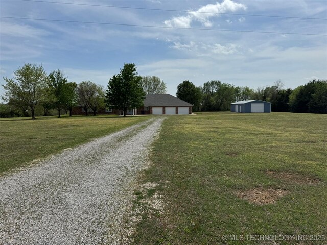 exterior space featuring driveway and a pole building