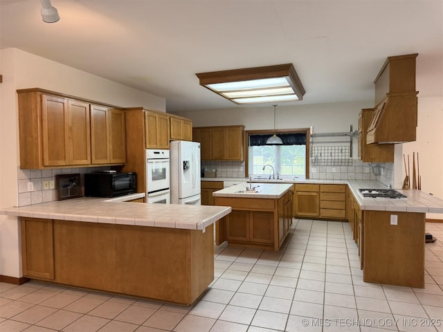 402325 W 2100th Rd, Bartlesville, OK 74006 - kitchen with white appliances, tasteful backsplash, and a peninsula