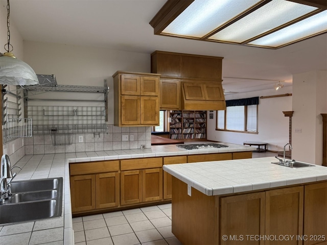 402325 W 2100th Rd, Bartlesville, OK 74006 - kitchen featuring a sink, white gas cooktop, brown cabinetry, and light tile patterned floors