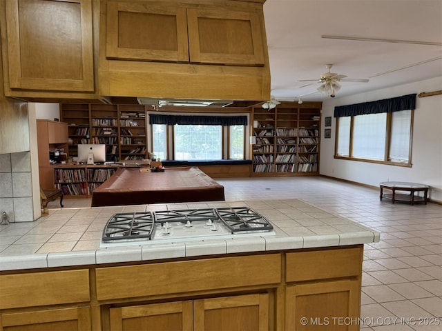 402325 W 2100th Rd, Bartlesville, OK 74006 - kitchen with healthy amount of natural light, a ceiling fan, tile counters, and light tile patterned flooring