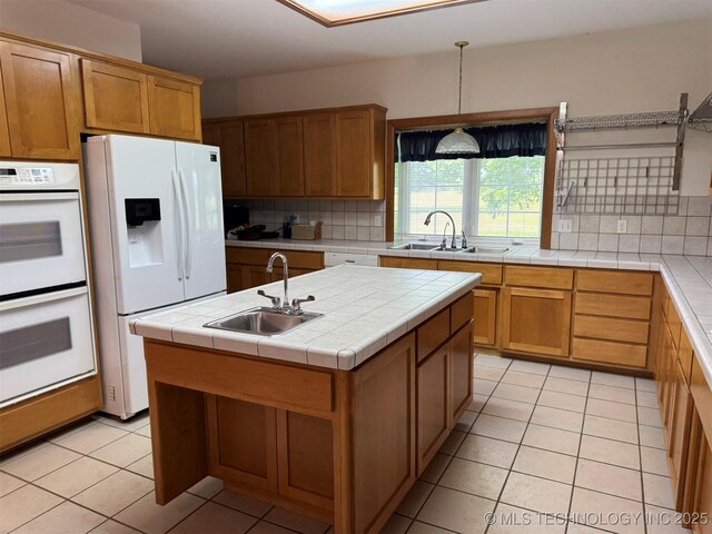 402325 W 2100th Rd, Bartlesville, OK 74006 - kitchen featuring white appliances, a sink, tasteful backsplash, and light tile patterned floors
