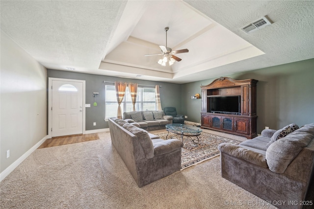 54555 E 340th Rd, Jay, OK 74346 - carpeted living area with a raised ceiling, visible vents, baseboards, and ceiling fan
