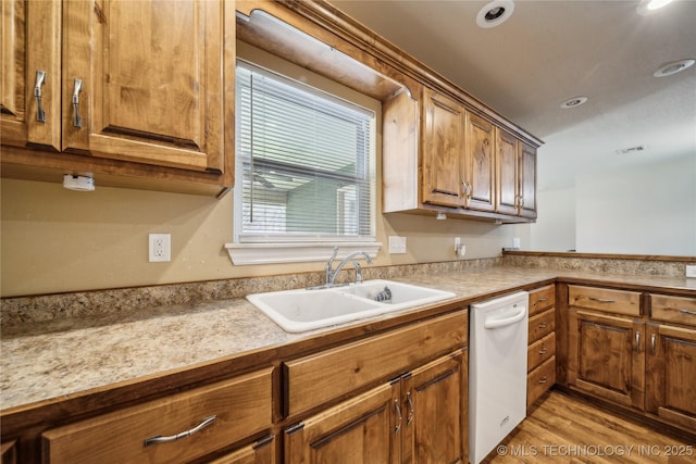 54555 E 340th Rd, Jay, OK 74346 - kitchen with light wood finished floors, a sink, visible vents, brown cabinetry, and light countertops