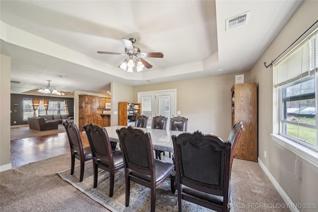 54555 E 340th Rd, Jay, OK 74346 - dining space with light colored carpet, baseboards, visible vents, and a raised ceiling