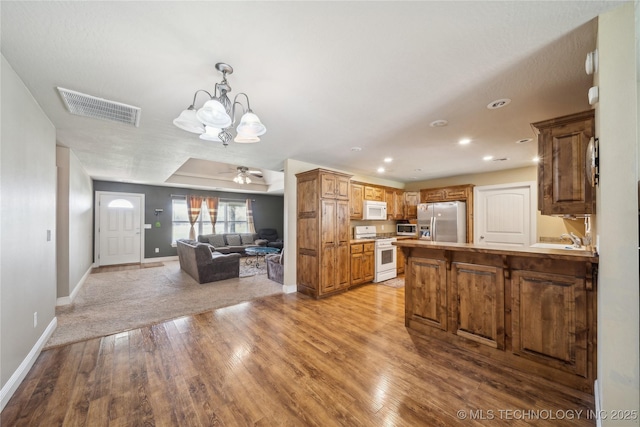 54555 E 340th Rd, Jay, OK 74346 - kitchen with light wood finished floors, stainless steel appliances, visible vents, a peninsula, and open floor plan