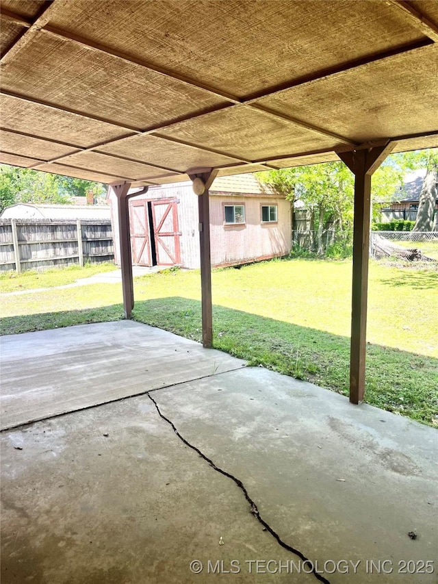 view of patio / terrace featuring an outdoor structure and fence