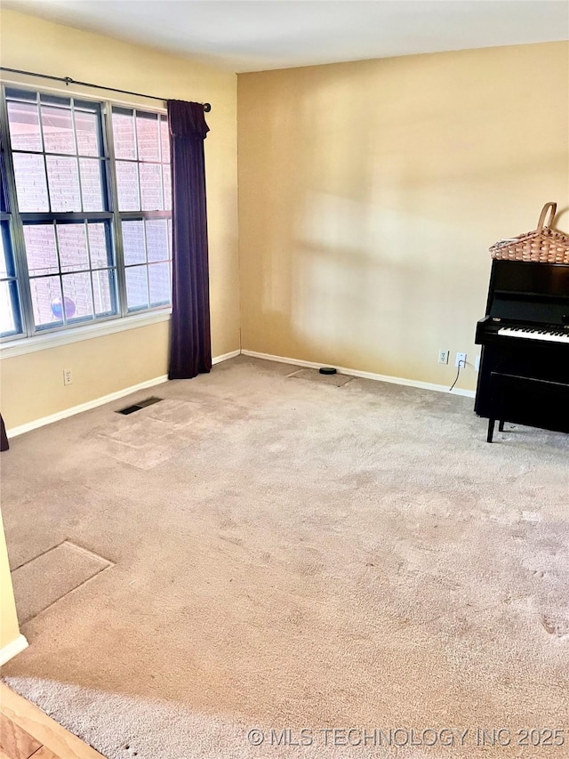 interior space with visible vents, carpet flooring, and baseboards