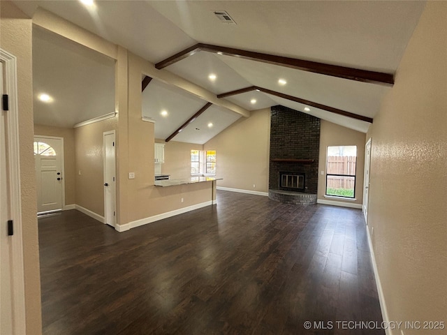 13802 E 19th Pl, Tulsa, OK 74108 - unfurnished living room featuring vaulted ceiling with beams, baseboards, recessed lighting, and dark wood finished floors