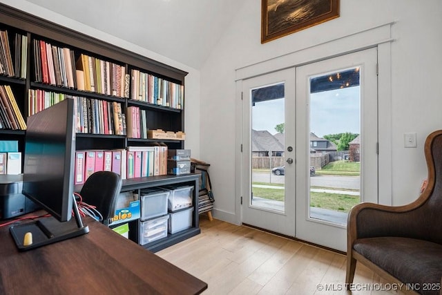 office featuring lofted ceiling, french doors, and wood finished floors