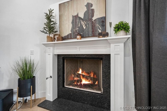 interior details featuring a warm lit fireplace