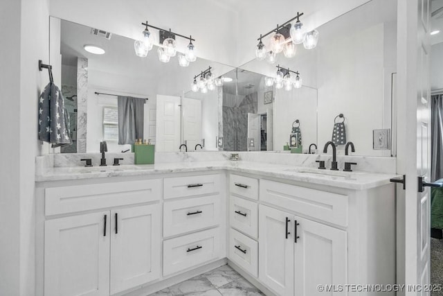 bathroom featuring visible vents, a sink, marble finish floor, and double vanity