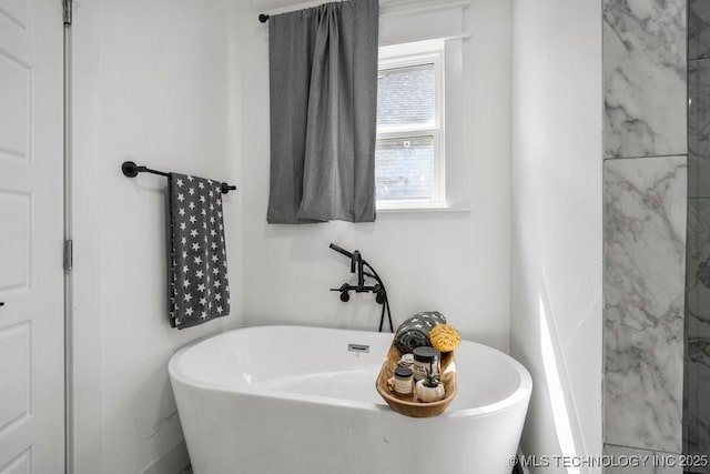 bathroom with a freestanding bath