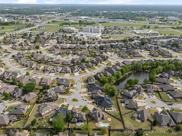 drone / aerial view featuring a water view and a residential view