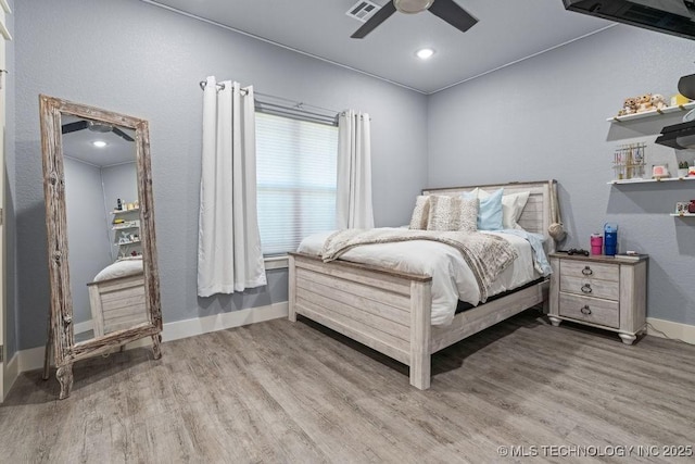 bedroom featuring visible vents, baseboards, and wood finished floors