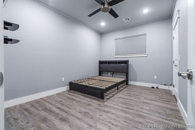 bedroom with baseboards, visible vents, recessed lighting, a ceiling fan, and wood finished floors
