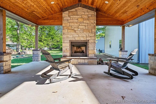 view of patio featuring an outdoor stone fireplace