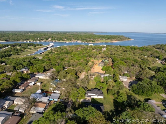 aerial view with a forest view, a residential view, and a water view