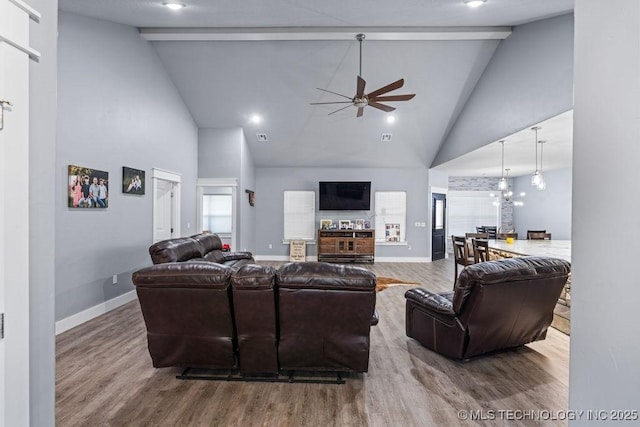 living room with baseboards, a ceiling fan, wood finished floors, and high vaulted ceiling