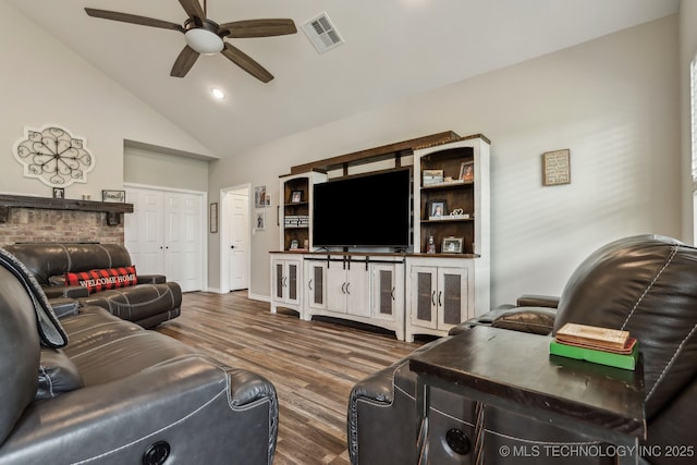 living area featuring visible vents, wood finished floors, high vaulted ceiling, recessed lighting, and a ceiling fan