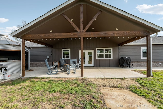 back of house with french doors, board and batten siding, and a patio area