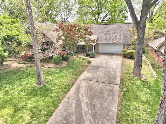 3638 E 69th Pl, Tulsa, OK 74136 - view of front of property with an attached garage, driveway, brick siding, roof with shingles, and a front yard