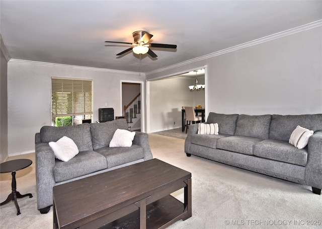 3638 E 69th Pl, Tulsa, OK 74136 - living room with ceiling fan with notable chandelier, carpet, stairway, and crown molding