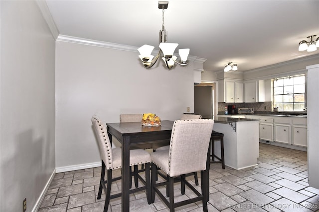 3638 E 69th Pl, Tulsa, OK 74136 - dining area featuring ornamental molding, stone tile floors, a toaster, baseboards, and a notable chandelier