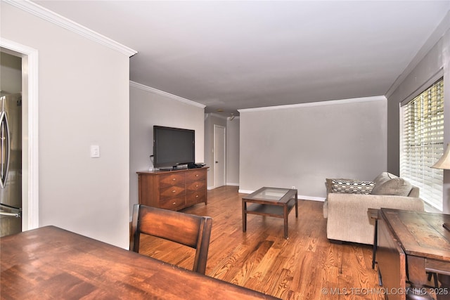 3638 E 69th Pl, Tulsa, OK 74136 - living area featuring wood finished floors, baseboards, and ornamental molding