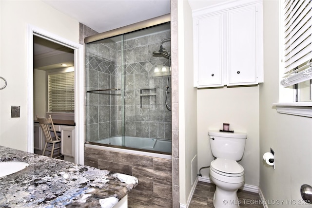 3638 E 69th Pl, Tulsa, OK 74136 - bathroom featuring baseboards, toilet, vanity, and tiled shower / bath