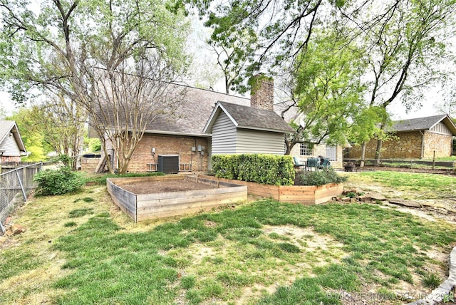 3638 E 69th Pl, Tulsa, OK 74136 - view of yard with a garden, central AC unit, and fence