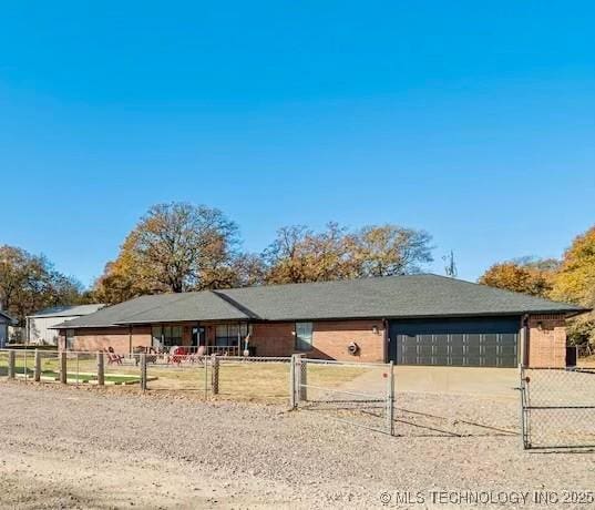 view of front of property featuring driveway, fence, and a garage