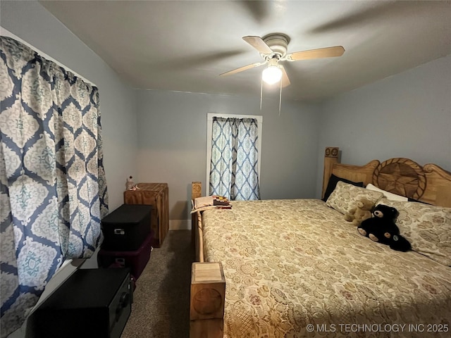 bedroom featuring dark colored carpet, baseboards, and a ceiling fan