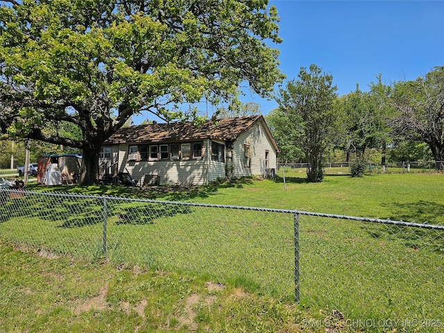 exterior space featuring a fenced backyard and a front yard
