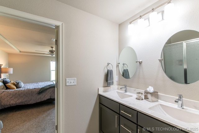 full bath featuring a shower with shower door, ensuite bath, a ceiling fan, and a sink