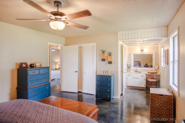 3745 E 420th Rd, Adair, OK 74330 - bedroom with a closet, a textured ceiling, finished concrete flooring, and a ceiling fan