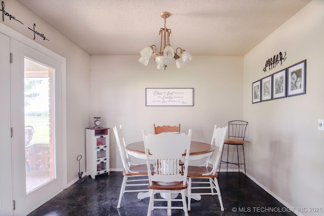3745 E 420th Rd, Adair, OK 74330 - dining area with a textured ceiling, finished concrete flooring, baseboards, and an inviting chandelier
