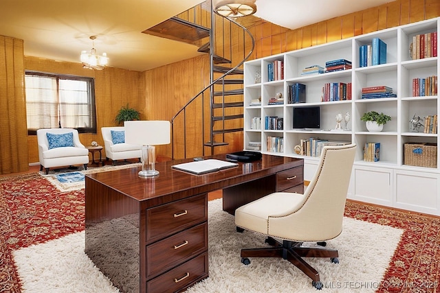 office space with wood walls and a chandelier