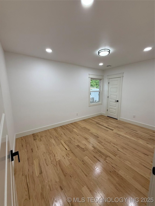unfurnished room with recessed lighting, light wood-type flooring, and baseboards