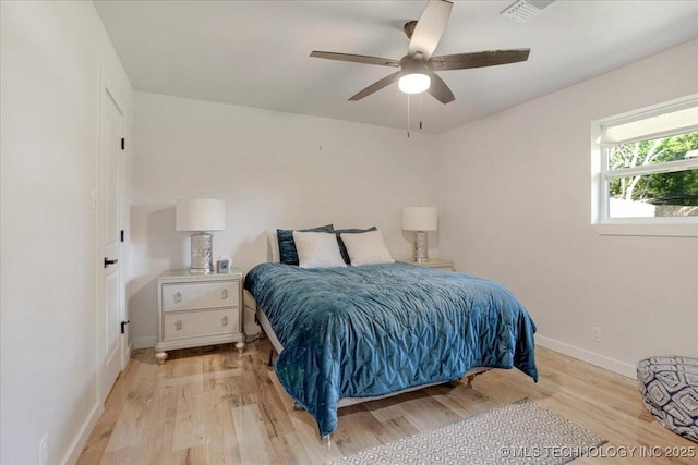 bedroom featuring ceiling fan, baseboards, visible vents, and light wood-type flooring