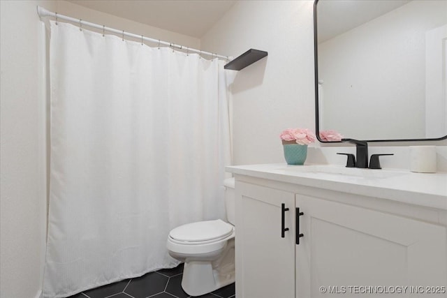 bathroom featuring vanity, tile patterned flooring, and toilet