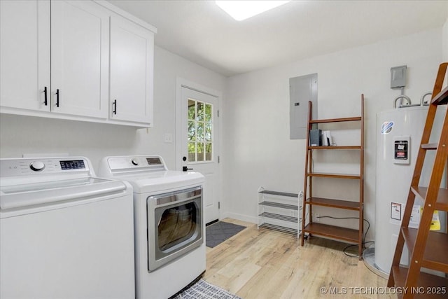 washroom with light wood finished floors, washer and clothes dryer, electric panel, cabinet space, and electric water heater