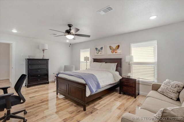 bedroom featuring ceiling fan, light wood-style flooring, baseboards, visible vents, and recessed lighting