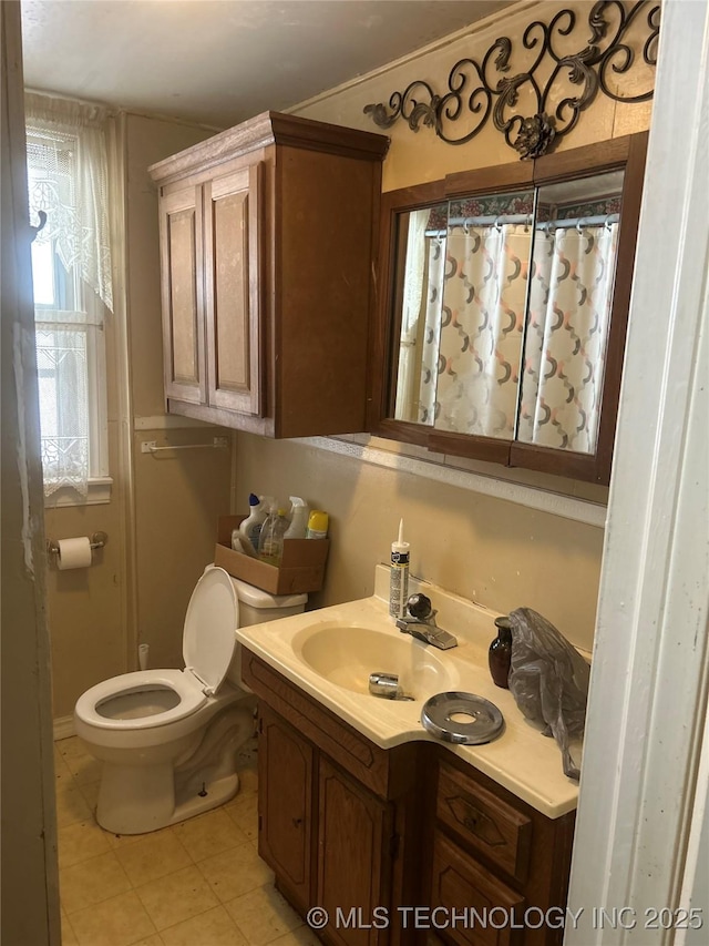 full bath with tile patterned floors, vanity, curtained shower, and toilet