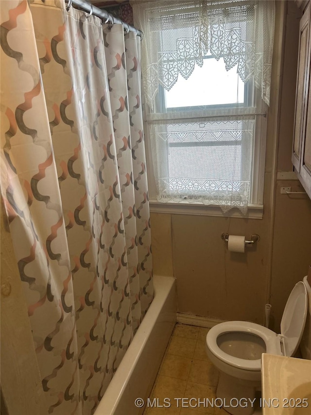 bathroom featuring shower / bath combination with curtain, toilet, and tile patterned flooring