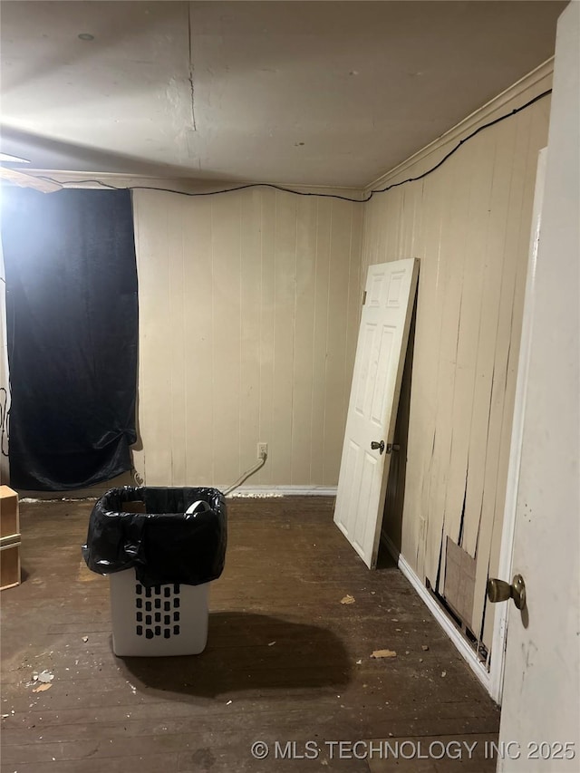 basement featuring wood walls