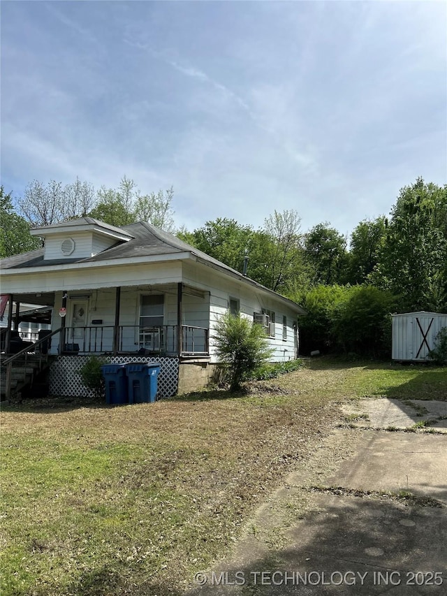 view of property exterior featuring a lawn and a porch