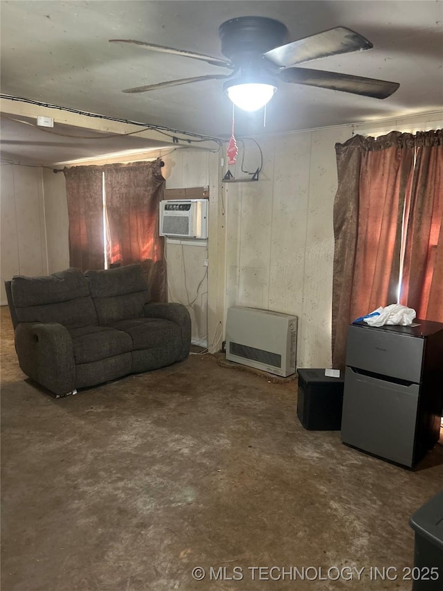 living room with wooden walls, concrete floors, heating unit, and a wall mounted AC